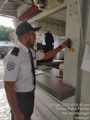 Security officer checking a patrol point on site
