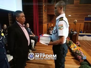 Officer receiving recognition at a company event
